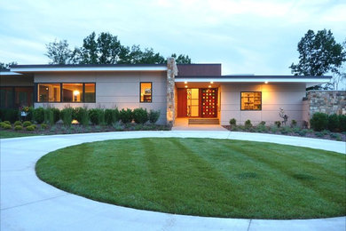 Modern beige one-story stucco flat roof idea in Nashville