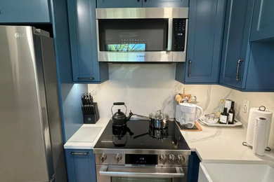 Example of a small beach style l-shaped vinyl floor, brown floor and shiplap ceiling eat-in kitchen design in Miami with a farmhouse sink, shaker cabinets, quartz countertops, yellow backsplash, quartz backsplash, stainless steel appliances, no island and white countertops