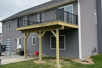 Deck - mid-sized backyard second story metal railing deck idea in New York