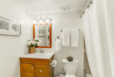 Small transitional master ceramic tile bathroom photo in Atlanta with recessed-panel cabinets and dark wood cabinets