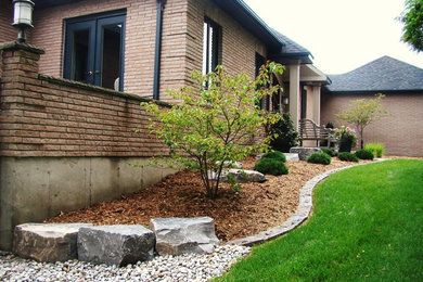 Mid-sized traditional brown one-story brick gable roof idea in Toronto