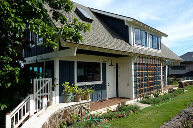 Mid-sized arts and crafts blue two-story wood and board and batten exterior home photo in Hawaii with a shingle roof and a gray roof