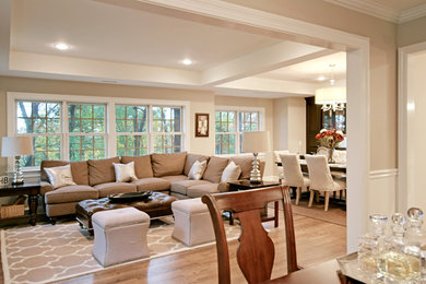 Living room - mid-sized traditional open concept dark wood floor living room idea in New York with beige walls, no fireplace and a wall-mounted tv