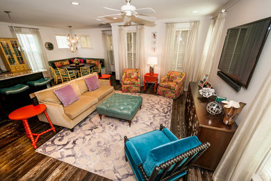 Example of a mid-sized eclectic open concept dark wood floor living room design in Miami with white walls and a wall-mounted tv