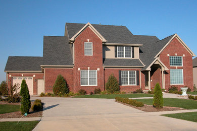 Elegant two-story brick exterior home photo in Other