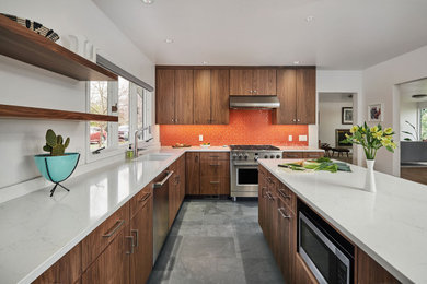 Example of a trendy u-shaped slate floor and gray floor eat-in kitchen design in Portland with an undermount sink, flat-panel cabinets, dark wood cabinets, quartz countertops, orange backsplash, ceramic backsplash, stainless steel appliances, an island and white countertops