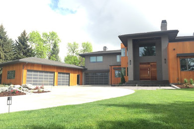 Inspiration for a large contemporary gray two-story mixed siding house exterior remodel in Denver with a hip roof and a tile roof