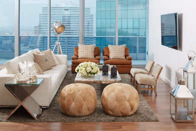 This is an example of a contemporary living room in Miami with white walls and a wall-mounted tv.