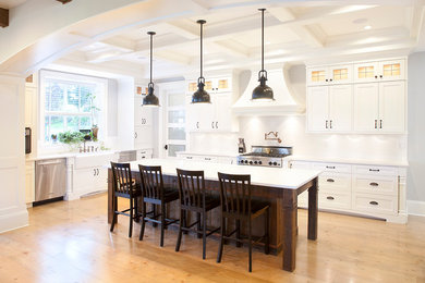 Design ideas for a large transitional l-shaped kitchen in Vancouver with a farmhouse sink, shaker cabinets, white cabinets, granite benchtops, white splashback, ceramic splashback, stainless steel appliances, medium hardwood floors and with island.