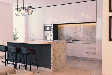 Large single-wall open plan kitchen in Sydney with a drop-in sink, beaded inset cabinets, black appliances, concrete floors, with island, black floor, marble benchtops, white cabinets, white splashback and marble splashback.