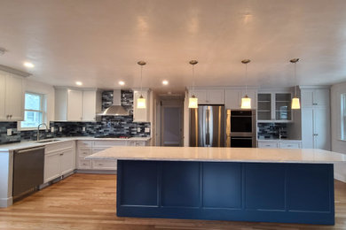 Example of a large minimalist l-shaped multicolored floor and medium tone wood floor eat-in kitchen design in Boston with an undermount sink, shaker cabinets, gray cabinets, quartz countertops, blue backsplash, porcelain backsplash, stainless steel appliances, an island and white countertops