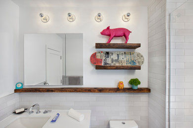This is an example of a mid-sized contemporary bathroom in New York with white walls and an undermount sink.