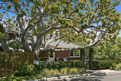 Design ideas for a mid-sized craftsman partial sun backyard stone landscaping in Orange County for summer.