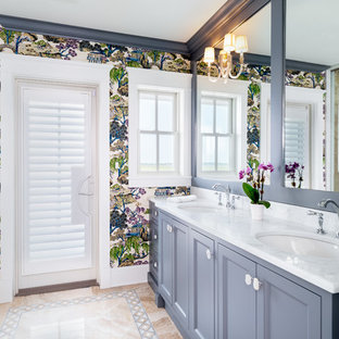 Example of a large coastal master beige tile and marble tile marble floor and multicolored floor wet room design in Philadelphia with recessed-panel cabinets, gray cabinets, pink walls, an undermount sink, marble countertops, a hinged shower door and yellow countertops