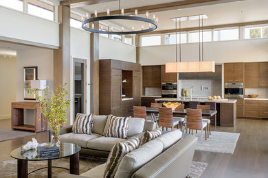 Inspiration for a large contemporary open concept dark wood floor living room remodel in Seattle with white walls