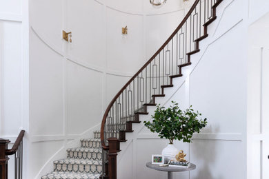 Staircase - transitional carpeted curved mixed material railing and wall paneling staircase idea in Dallas with carpeted risers