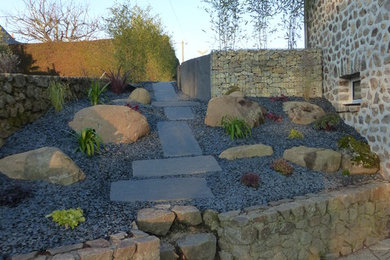 Inspiration for a small country partial sun xeriscape in Other with a garden path and gravel.