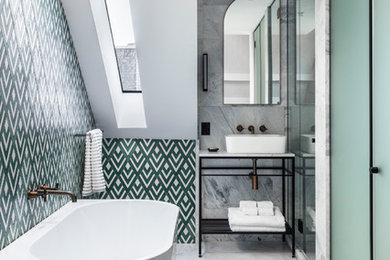 This is an example of a transitional bathroom in Sydney with a freestanding tub, multi-coloured tile, white walls, a vessel sink and grey floor.