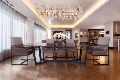 Example of a large trendy medium tone wood floor and brown floor kitchen/dining room combo design in Denver with gray walls
