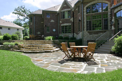 Inspiration for a mid-sized timeless backyard tile patio remodel in Chicago with no cover