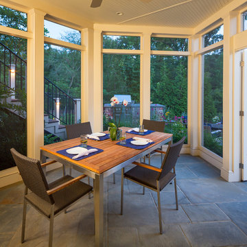 Screen porch with view of the garden and grill