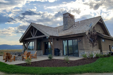 Inspiration for a large rustic backyard patio remodel in Other with a fire pit and no cover