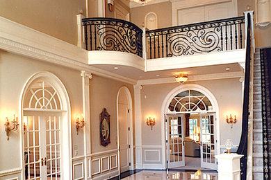 Large elegant porcelain tile and beige floor entryway photo in Cleveland with beige walls and a white front door