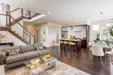 Inspiration for a mid-sized contemporary open concept dark wood floor and brown floor family room remodel in Other with beige walls, no fireplace and no tv