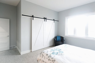 Transitional guest carpeted bedroom photo in Calgary with no fireplace