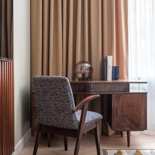 This is an example of a modern study in Moscow with white walls, light hardwood flooring, a freestanding desk and beige floors.