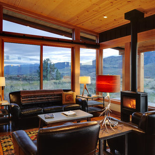 Repräsentatives, Fernseherloses, Offenes, Mittelgroßes Mediterranes Wohnzimmer mit braunem Holzboden, Kaminofen, brauner Wandfarbe, Kaminsims aus Metall und braunem Boden in Seattle