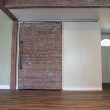 Exposed wood beams with barn door