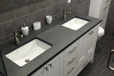 Minimalist master gray tile and ceramic tile ceramic tile double shower photo in New York with an undermount sink, shaker cabinets, white cabinets, quartzite countertops, a wall-mount toilet and white walls