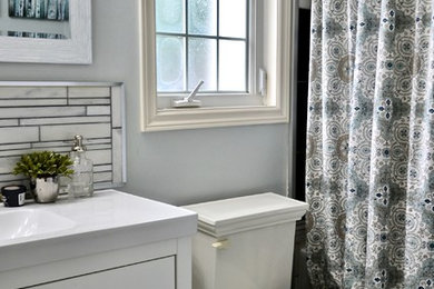 Photo of a mid-sized country master bathroom in Toronto with furniture-like cabinets, white cabinets, gray tile, marble and blue walls.