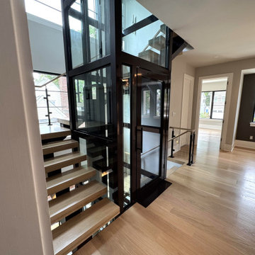 Project #136 | Modern Floating Staircase Encircling Glass Elevator