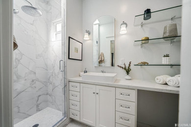 Alcove shower - small transitional master white tile and porcelain tile single-sink, ceramic tile and white floor alcove shower idea in San Francisco with white cabinets, a hinged shower door, white countertops, shaker cabinets, a one-piece toilet, white walls, a vessel sink, quartz countertops and a built-in vanity
