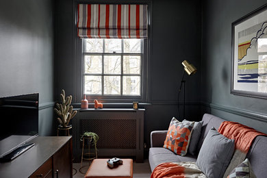 This is an example of a small eclectic kids' room for boys in London with black walls, carpet and grey floor.