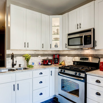 White Kitchen Remodel with Colonial White Granite and Stainless Steel Appliances