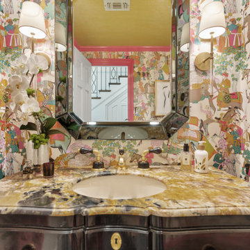 Vibrant and Eclectic Powder Room with Bold Wallpaper and Luxurious Vanity