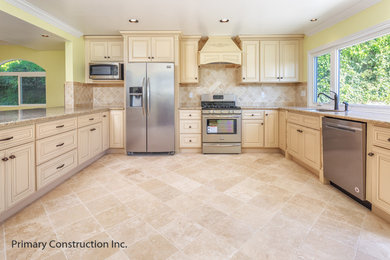 Example of a large tuscan kitchen design in Los Angeles with black backsplash and an island