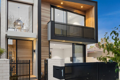 This is an example of a contemporary multi-coloured house exterior in Melbourne with a flat roof.