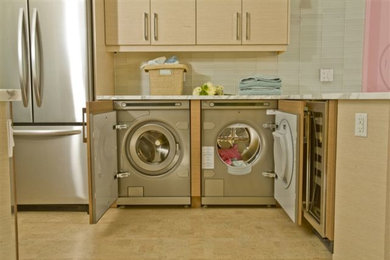 Mid-sized transitional galley ceramic tile utility room photo in Milwaukee with a drop-in sink, flat-panel cabinets, light wood cabinets, marble countertops and a side-by-side washer/dryer