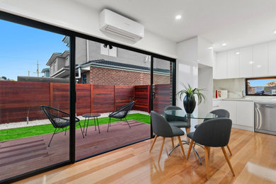 This is an example of a modern dining room in Melbourne.