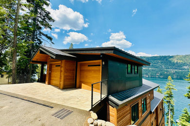 Example of a large mountain style four-story mixed siding house exterior design in Sacramento with a shed roof and a metal roof