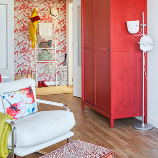 Mid-sized eclectic foyer in Malaga with white walls, medium hardwood floors and a single front door.
