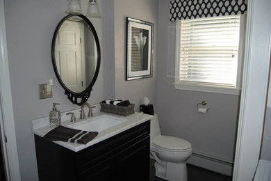 Bathroom - mid-sized modern 3/4 slate floor bathroom idea in Boston with an undermount sink, raised-panel cabinets, black cabinets, marble countertops, a one-piece toilet and gray walls