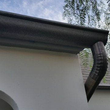 Bonderized Steel, 5 inch Half Round Seamless Gutters with Round Downspouts.