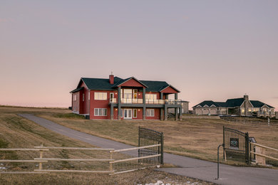 Inspiration for a huge craftsman red two-story vinyl exterior home remodel in Calgary with a shingle roof