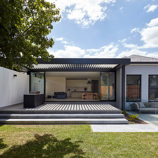 Inspiration for a contemporary one-storey stucco white house exterior in Melbourne with a hip roof and a shingle roof.