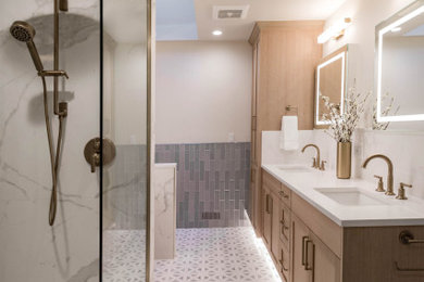 Example of a large minimalist master blue tile and ceramic tile mosaic tile floor, multicolored floor and double-sink walk-in shower design in Seattle with shaker cabinets, light wood cabinets, white walls, an undermount sink, quartz countertops, a hinged shower door, white countertops and a built-in vanity